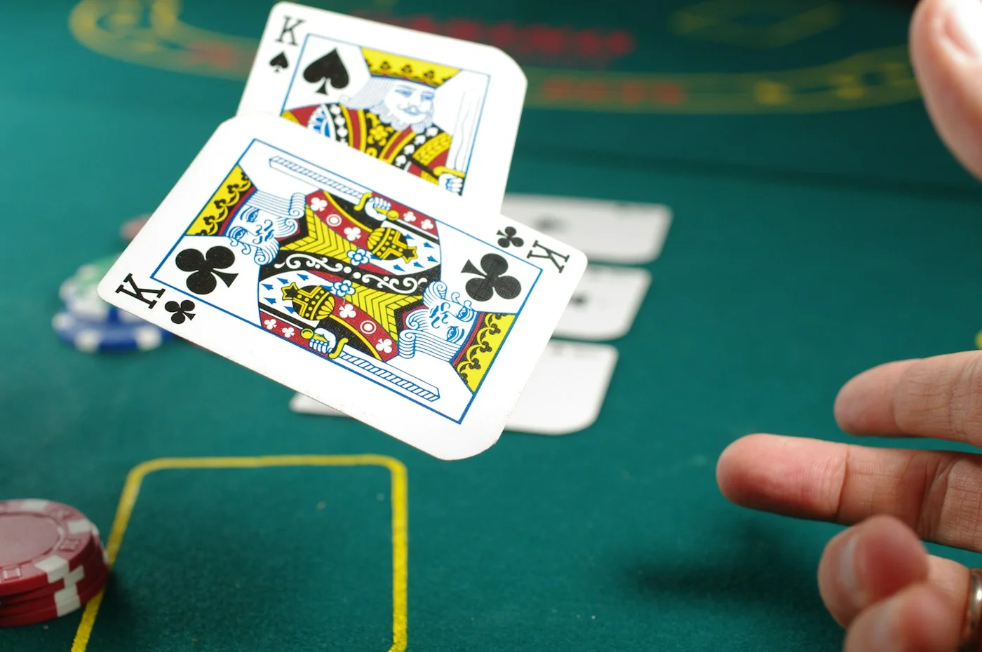 Playing cards and chips on a green casino table